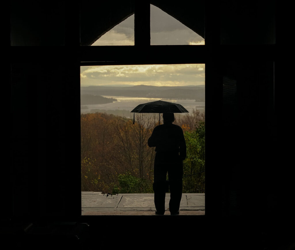An Olana visitor admires the "Bend in the River," October 2014 . Photo by Annik LaFarge, author of Composing Olana