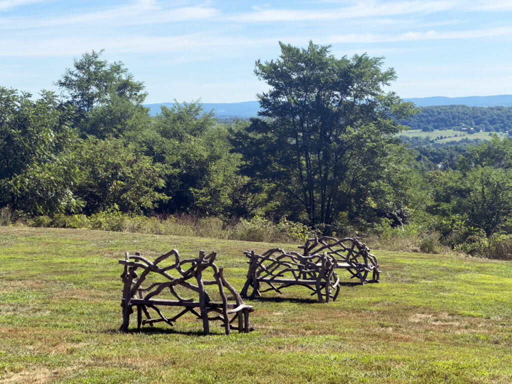 Three rustic benches in the picnic area of Ridge Road, August 2025. Photo by Annik LaFarge, author of Composing Olana