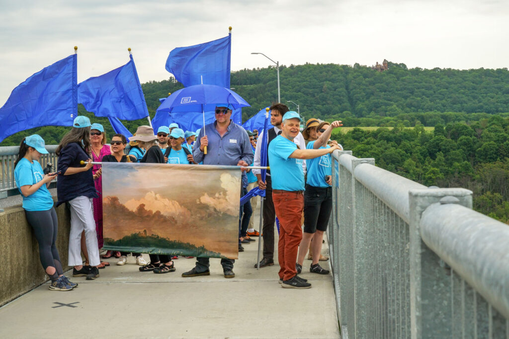 Marchers carrying Frederic Church's 1872 