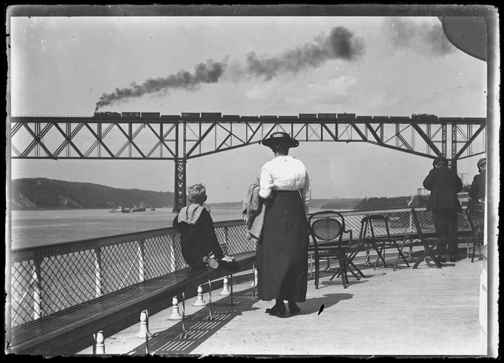 William Gray Hassler and Ethel Magaw Hassler on a Hudson River Day Line ferry from New York to Poughkeepsie, watching a train go over the Poughkeepsie Bridge, September 10, 1915. Photo courtesy The New-York Historical