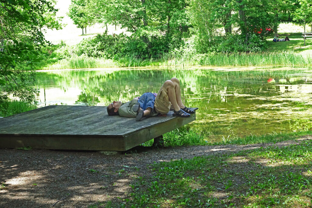 Father and son relax on the dock at the Olana Lake, June 2015. Photo by Annik LaFarge, author of Composing Olana