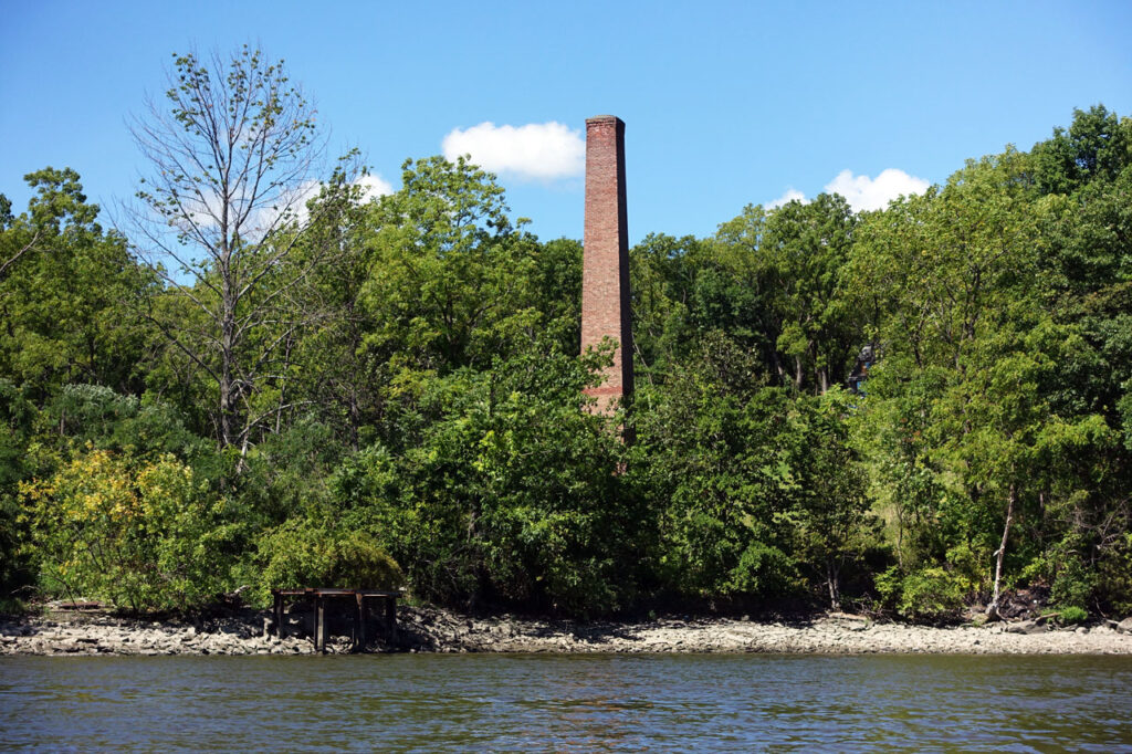 Brick chimney from the Knickerbocker Ice Company in Athens, NY, just across the Hudson from Mt. Merino, July 2021. Photo by Annik LaFarge, author of Composing Olana