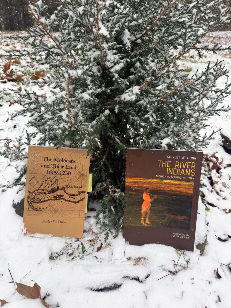 Two indispensable books for understanding the deep history of this beautiful place, photographed against an eastern red cedar on Mt. Merino. Photo by Annik LaFarge, author of Composing Olana