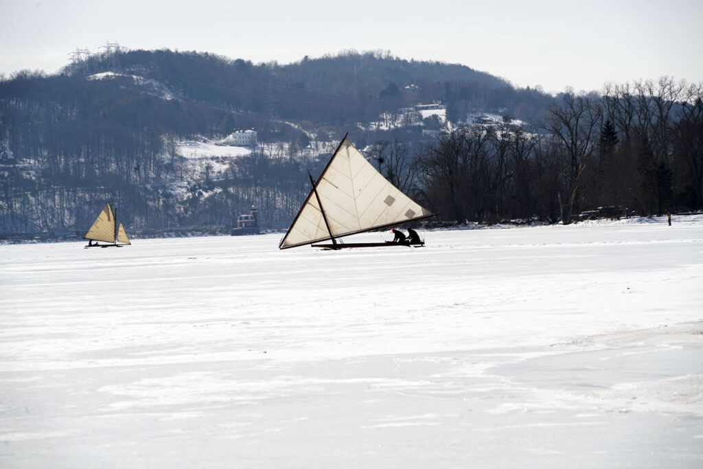 Ice yachters on the Hudson, with Mt. Merino and the Hudson-Athens Lighthouse in the background, February 15, 2026. Photo by Annik LaFarge, author of Composing Olana